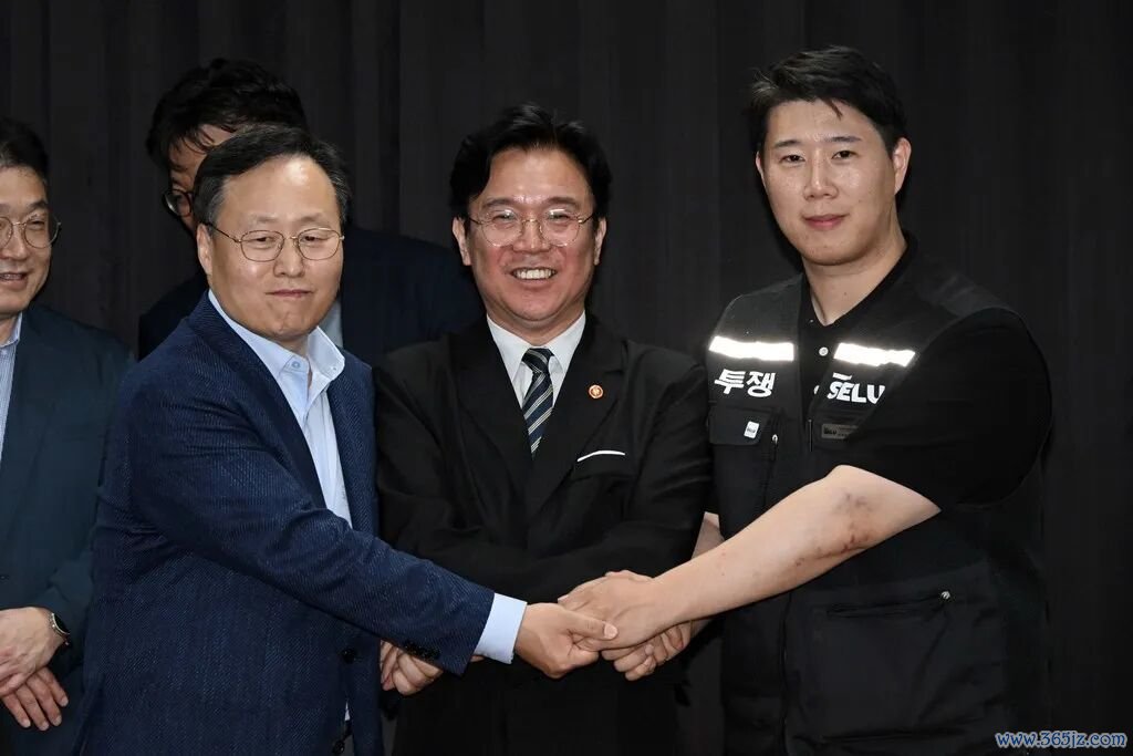 当地时间2026年5月20日，三星电子DS部门人事组长与三星集团初创企业工会三星电子支部委员长崔胜浩签署临时协议，随后与雇佣劳动部部长金英勋合影留念。图/视觉中国